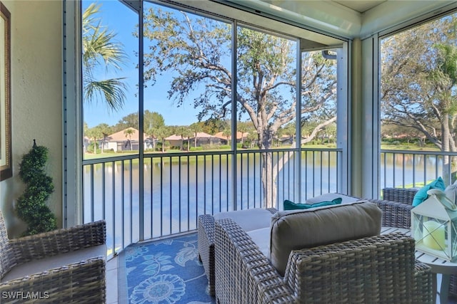 sunroom / solarium featuring a water view