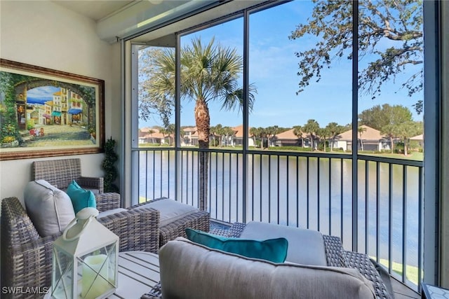 interior space featuring a water view, a residential view, and a wealth of natural light