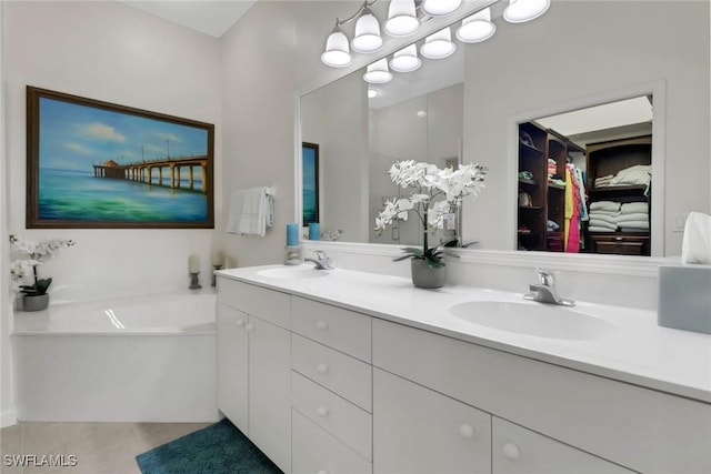 bathroom featuring tile patterned flooring, a garden tub, a sink, and double vanity