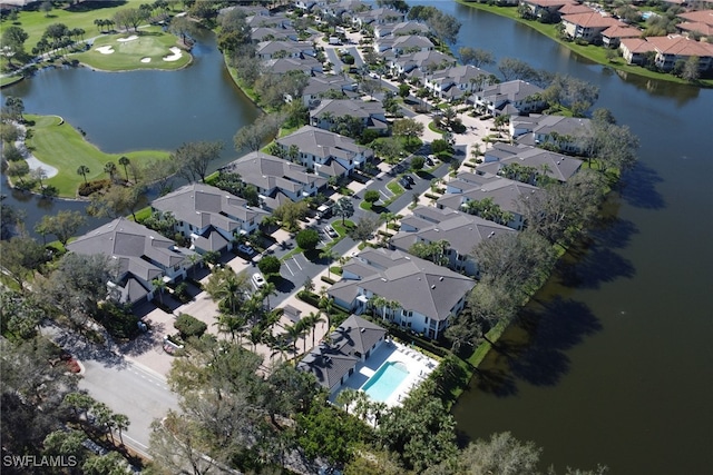 drone / aerial view featuring a water view and a residential view