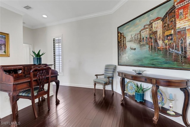 interior space featuring visible vents, crown molding, baseboards, and wood finished floors