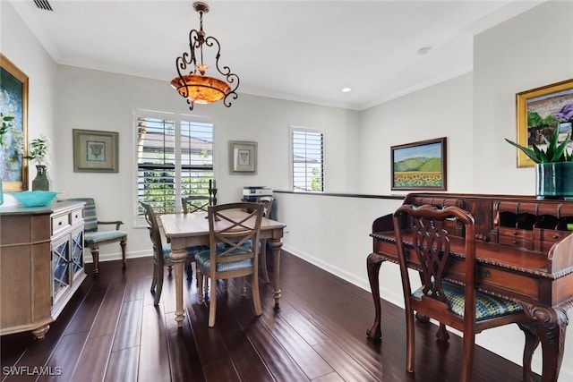 dining space with dark wood-style floors, baseboards, and ornamental molding