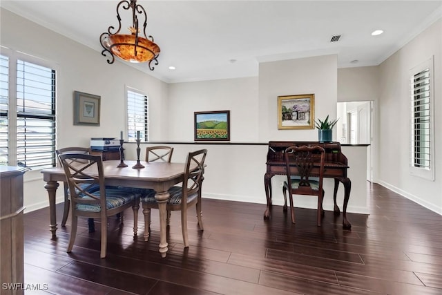 dining room featuring baseboards, dark wood-type flooring, and ornamental molding