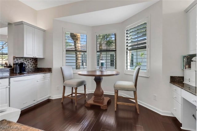 dining area with dark wood finished floors and baseboards