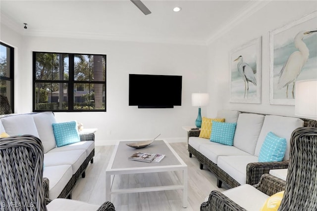 living area with ornamental molding, recessed lighting, and baseboards