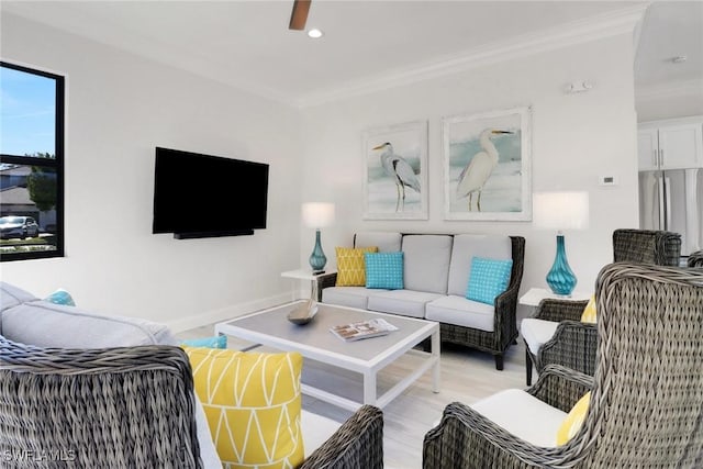 living area featuring baseboards, ornamental molding, recessed lighting, and light wood-style floors