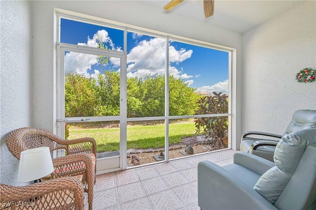 sunroom featuring ceiling fan