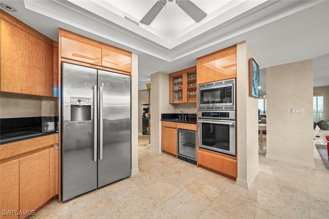 2619 Wulfert Rd Unit 6, Sanibel, FL 33957 - kitchen featuring a tray ceiling, appliances with stainless steel finishes, dark countertops, and glass insert cabinets