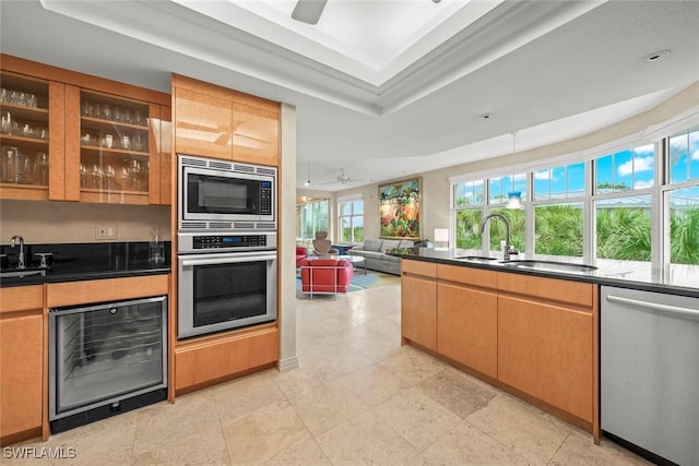 2619 Wulfert Rd Unit 6, Sanibel, FL 33957 - kitchen featuring a tray ceiling, stainless steel appliances, dark countertops, glass insert cabinets, and a sink