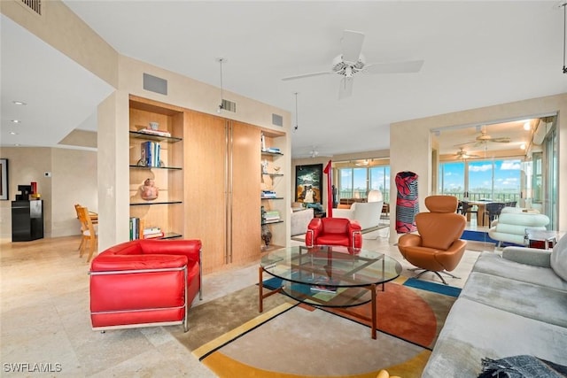 2619 Wulfert Rd Unit 6, Sanibel, FL 33957 - living area featuring visible vents, ceiling fan, built in shelves, and a wealth of natural light