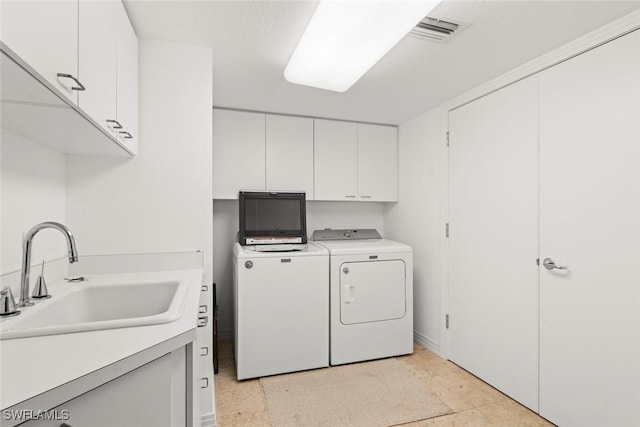 2619 Wulfert Rd Unit 6, Sanibel, FL 33957 - washroom with independent washer and dryer, cabinet space, a sink, and visible vents
