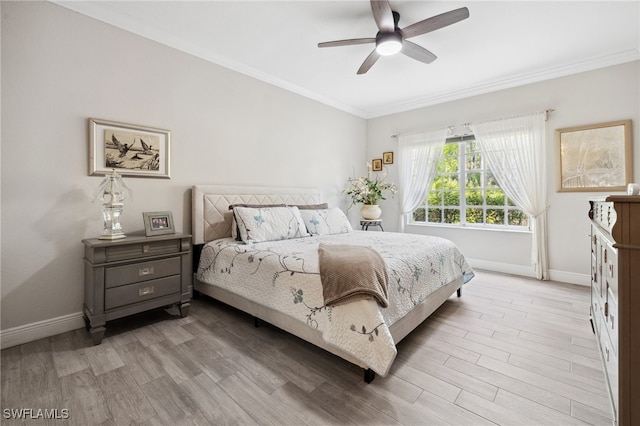 bedroom featuring light wood-type flooring, ceiling fan, baseboards, and crown molding