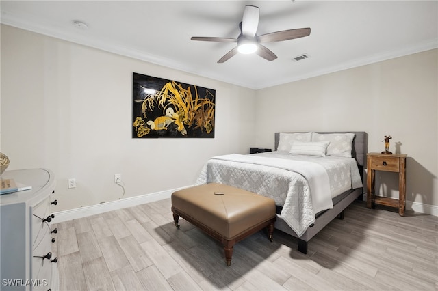 bedroom with baseboards, visible vents, ceiling fan, ornamental molding, and wood finished floors