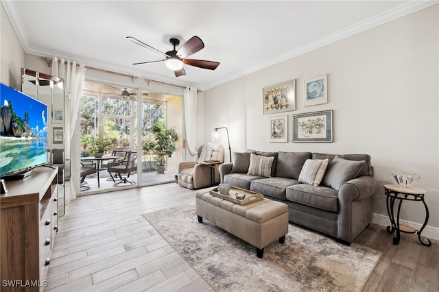 living area featuring ornamental molding, light wood-type flooring, baseboards, and a ceiling fan