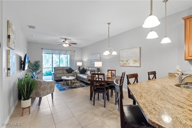 dining space featuring ceiling fan, light tile patterned flooring, visible vents, and baseboards