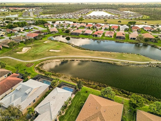 bird's eye view with view of golf course, a water view, and a residential view