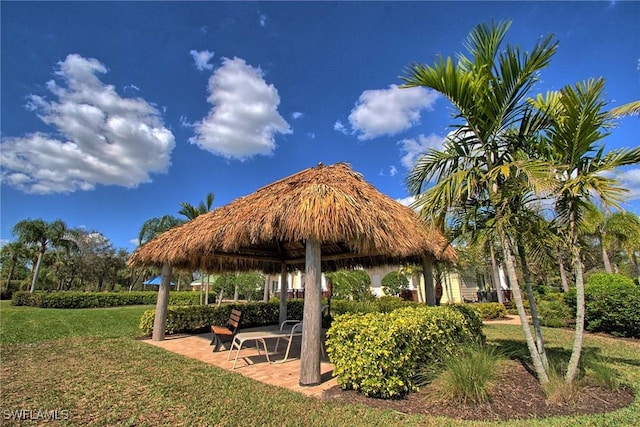 view of home's community with a lawn, a gazebo, and a patio