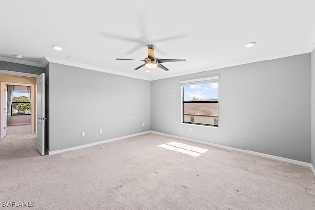 carpeted spare room featuring recessed lighting, ceiling fan, baseboards, and ornamental molding