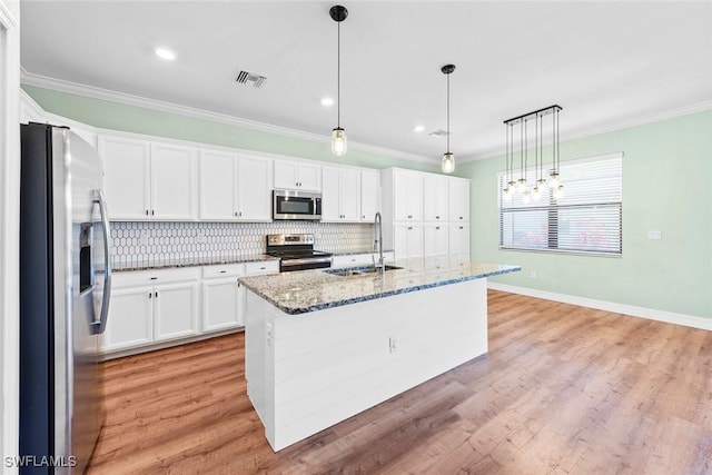 kitchen with ornamental molding, appliances with stainless steel finishes, a sink, and visible vents