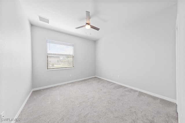 unfurnished room featuring carpet floors, ceiling fan, and baseboards