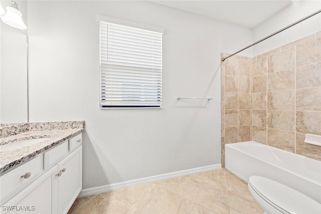 full bath featuring baseboards, toilet, tile patterned flooring, vanity, and washtub / shower combination