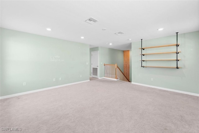 spare room with recessed lighting, visible vents, and baseboards