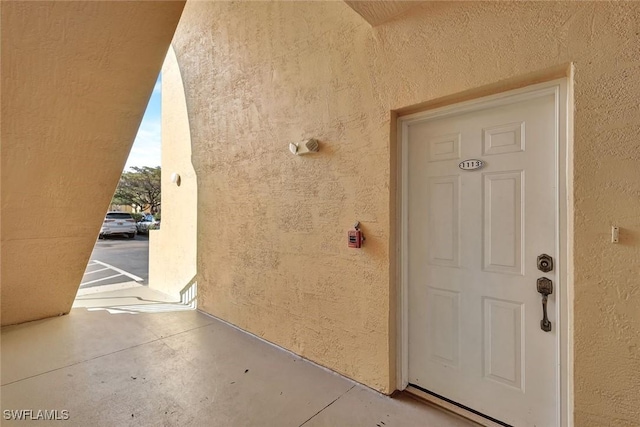 view of exterior entry with stucco siding