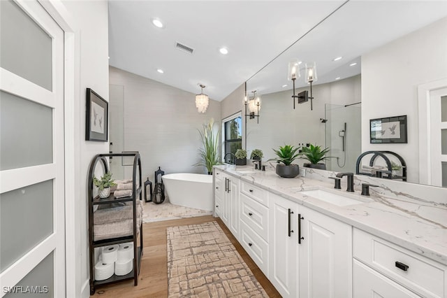 bathroom featuring a sink, visible vents, vaulted ceiling, a shower stall, and double vanity