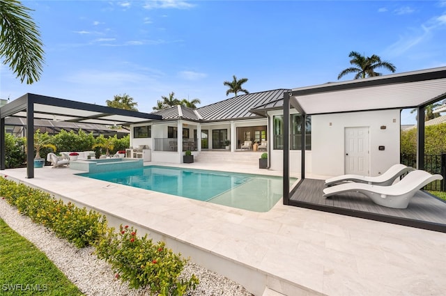 view of pool featuring a pool with connected hot tub, an outdoor living space, and a patio