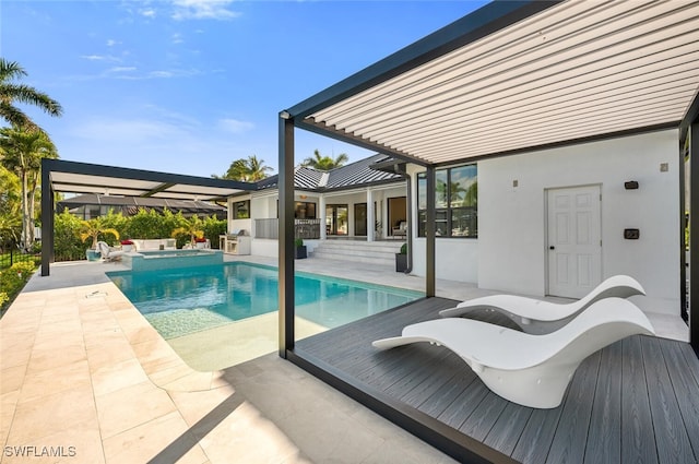 view of swimming pool with a patio area and a pool with connected hot tub