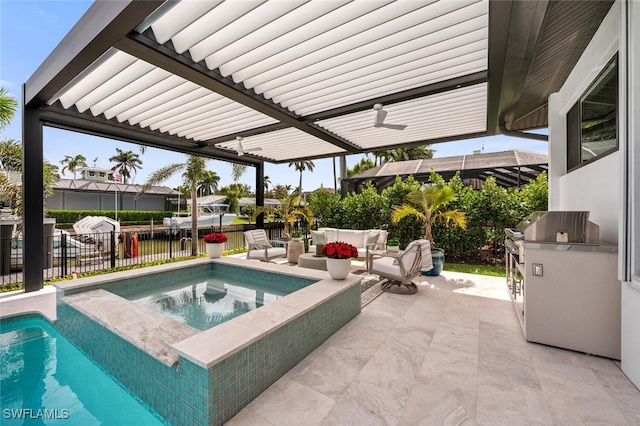 view of swimming pool with a patio, an in ground hot tub, fence, an outdoor living space, and exterior kitchen