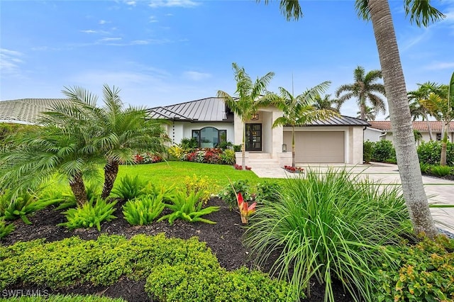 mediterranean / spanish home with a standing seam roof, metal roof, and stucco siding