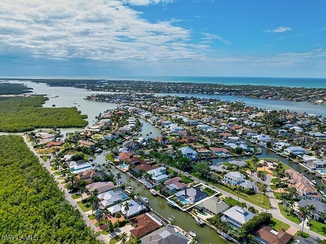 birds eye view of property with a water view and a residential view