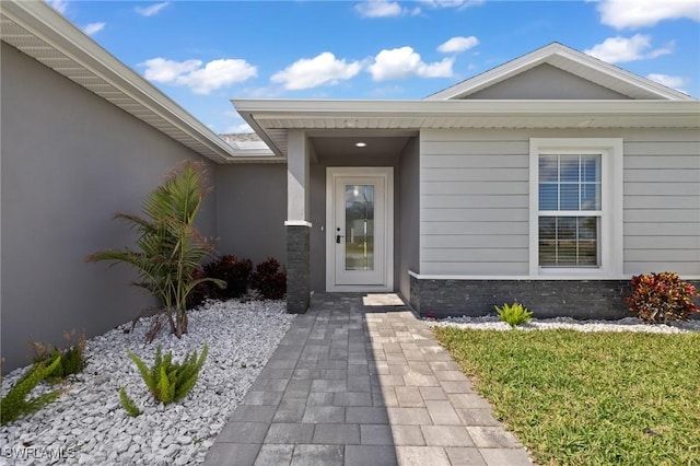 entrance to property with stucco siding