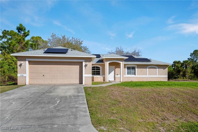 ranch-style house with stucco siding, solar panels, an attached garage, driveway, and a front lawn