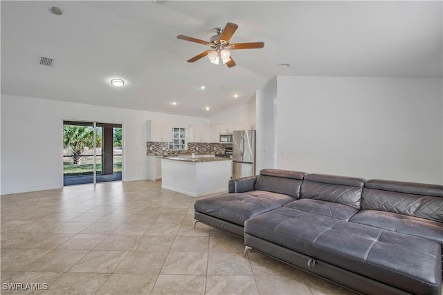 living room featuring vaulted ceiling, ceiling fan, light tile patterned flooring, and visible vents