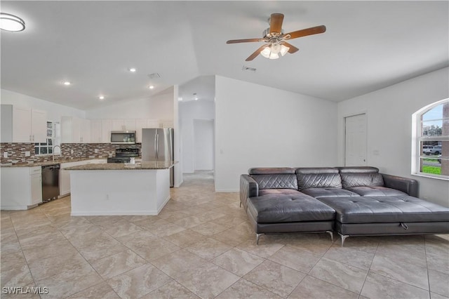 living room featuring vaulted ceiling, ceiling fan, and visible vents