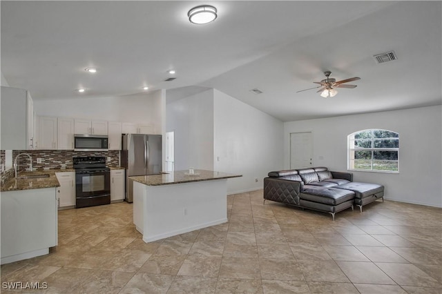 kitchen with stainless steel appliances, visible vents, open floor plan, a sink, and a kitchen island