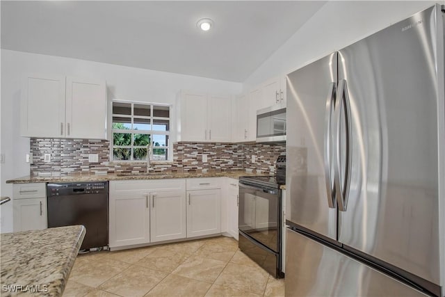 kitchen with decorative backsplash, white cabinets, light stone countertops, black appliances, and a sink