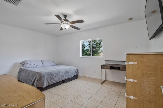 bedroom with ceiling fan, light tile patterned flooring, visible vents, and baseboards