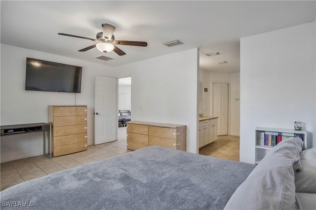 bedroom with light tile patterned floors, ceiling fan, visible vents, and connected bathroom