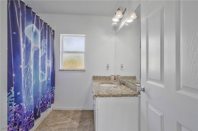 bathroom with a shower with shower curtain, tile patterned flooring, vanity, and baseboards