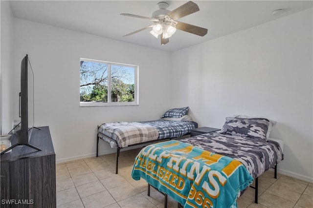 bedroom with light tile patterned floors, ceiling fan, and baseboards