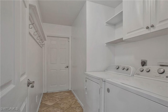 laundry room featuring washer and dryer, cabinet space, and baseboards