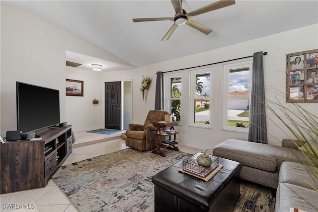 living room featuring light tile patterned floors, ceiling fan, and vaulted ceiling