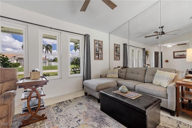 living room featuring lofted ceiling, light tile patterned floors, and ceiling fan