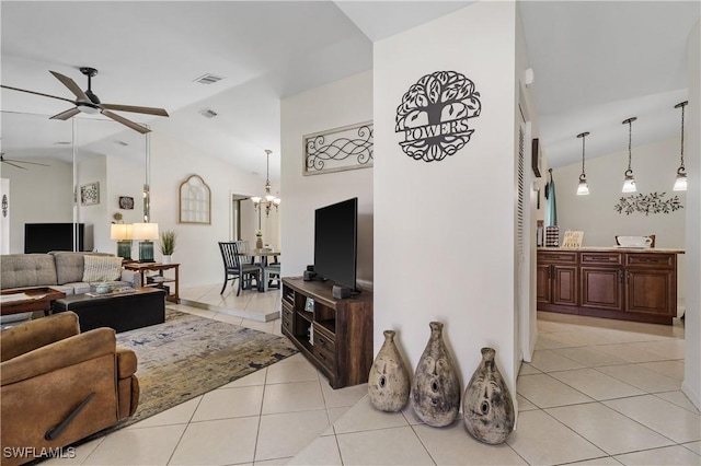 living room featuring light tile patterned floors, visible vents, high vaulted ceiling, and ceiling fan with notable chandelier