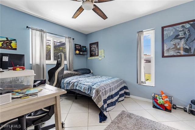 bedroom with baseboards, ceiling fan, and tile patterned floors