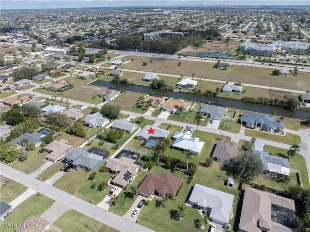 birds eye view of property with a water view and a residential view