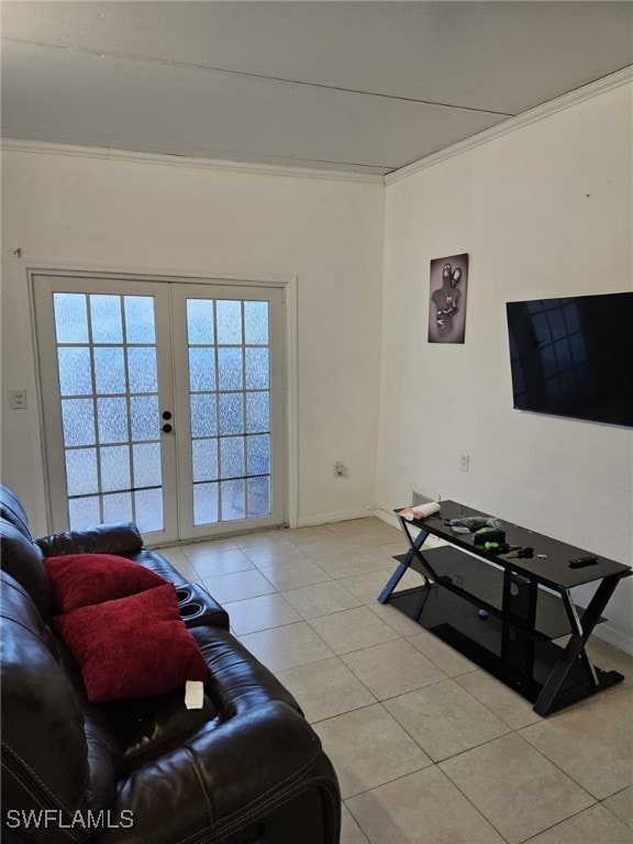 living room with light tile patterned floors, baseboards, crown molding, and french doors